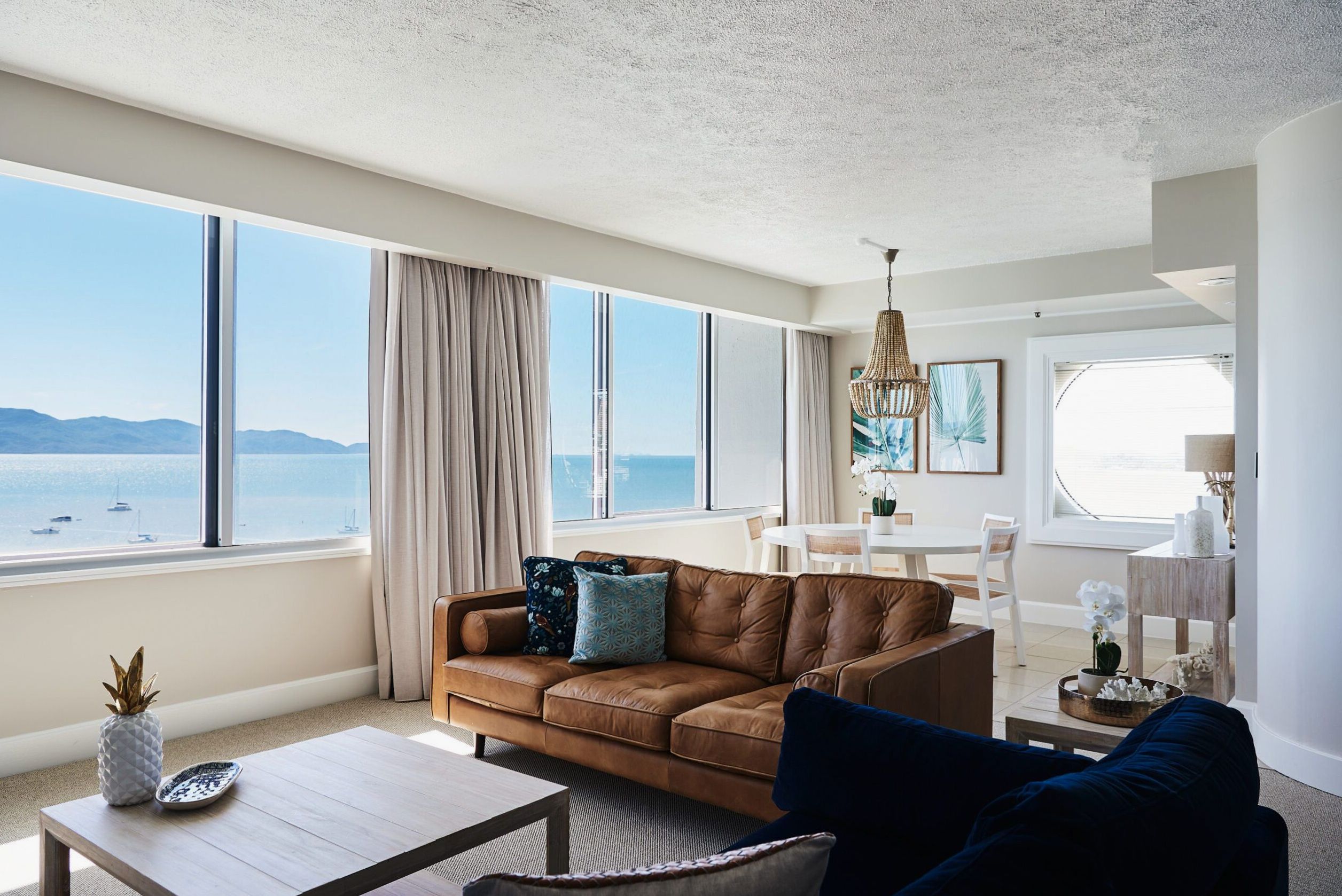 Pelorus Suite top-floor suite with ocean views, living and dining areas at The Ville